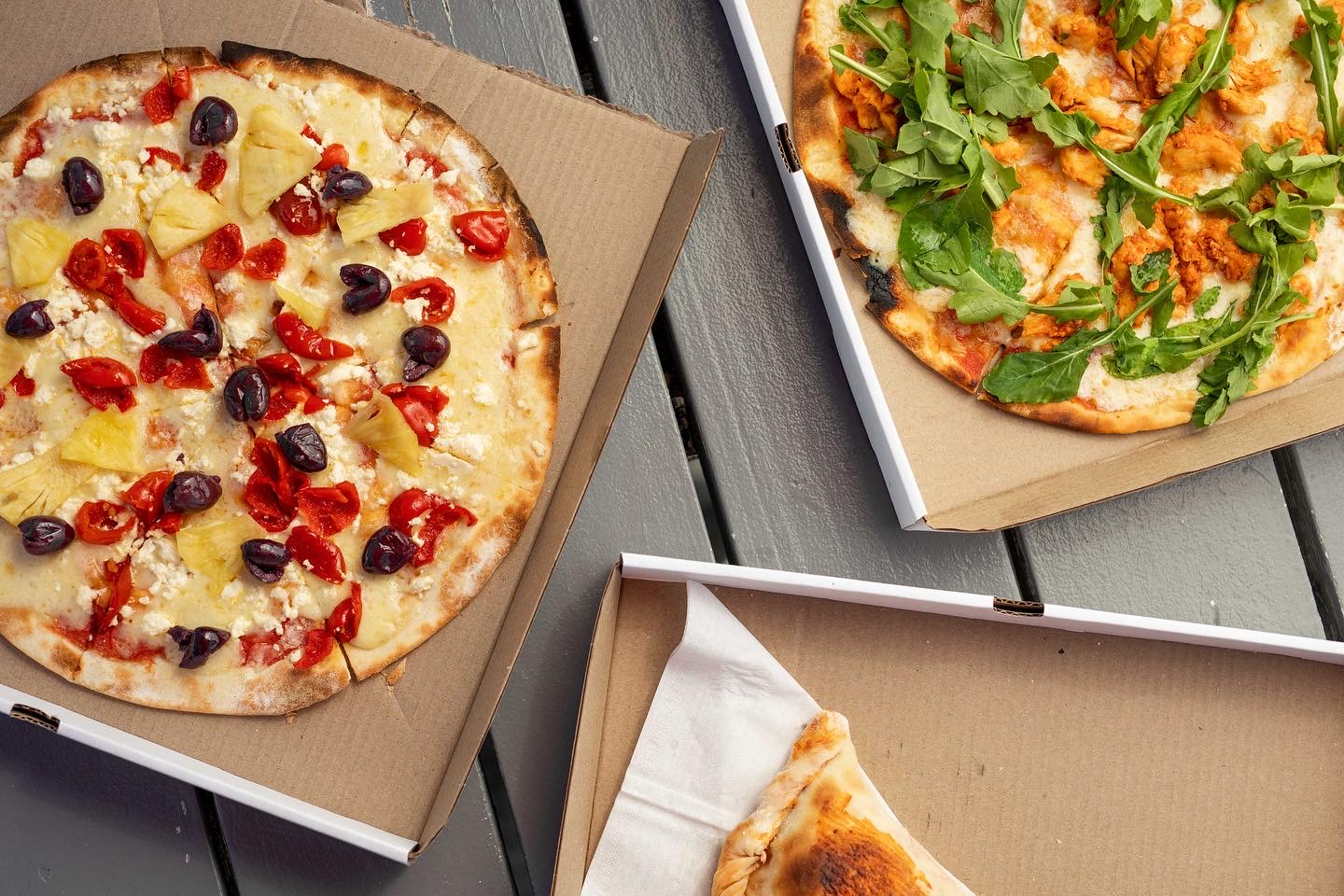 Wood-fired pizzas ready to be boxed